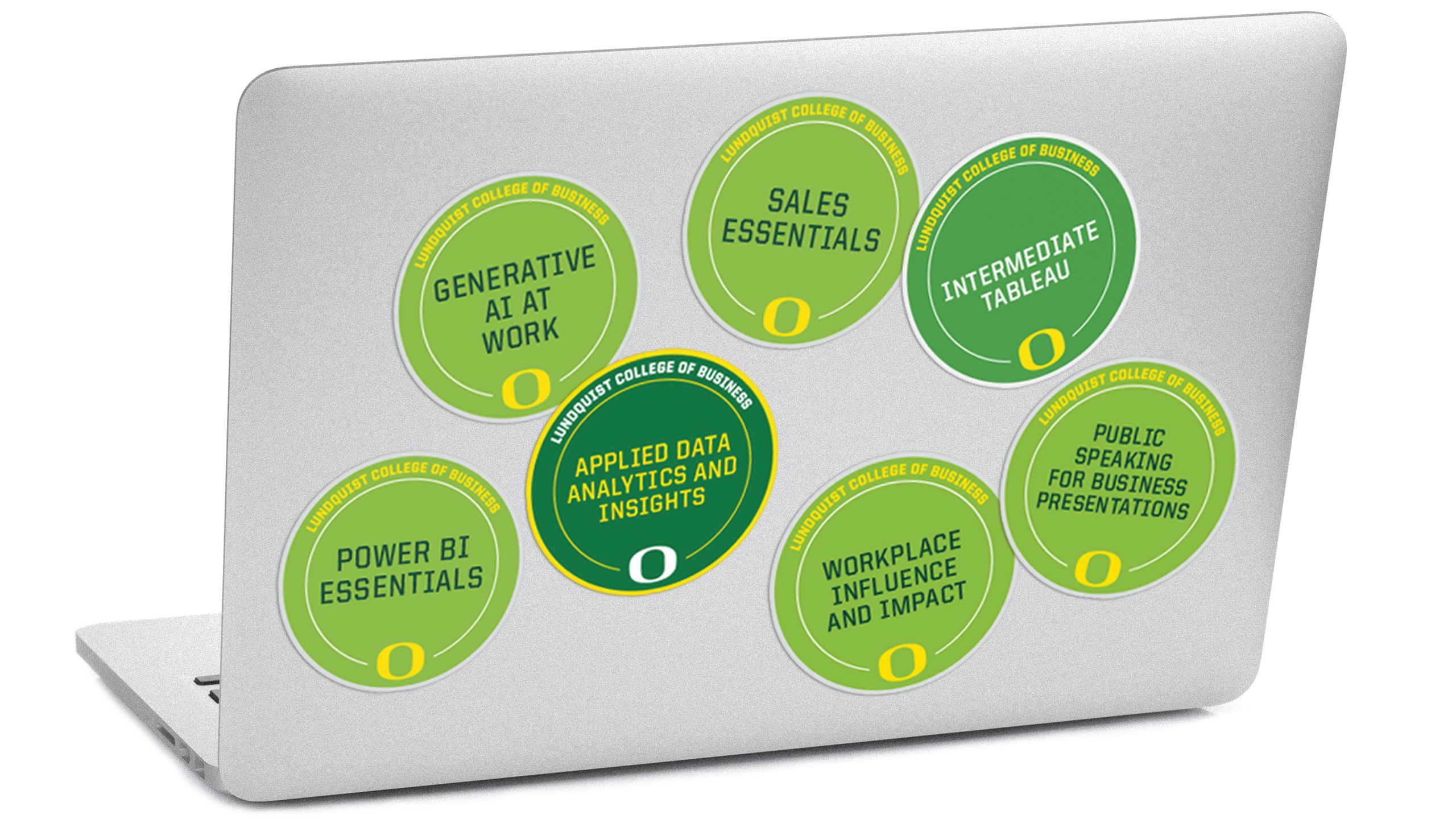 An image of the lid of a computer with multiple microcredential badges on it