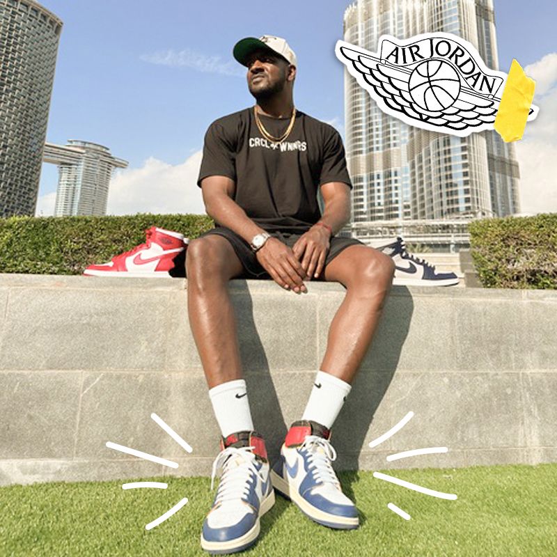 Garren Strong sitting on a cement wall, wearing Air Jordan shoes.