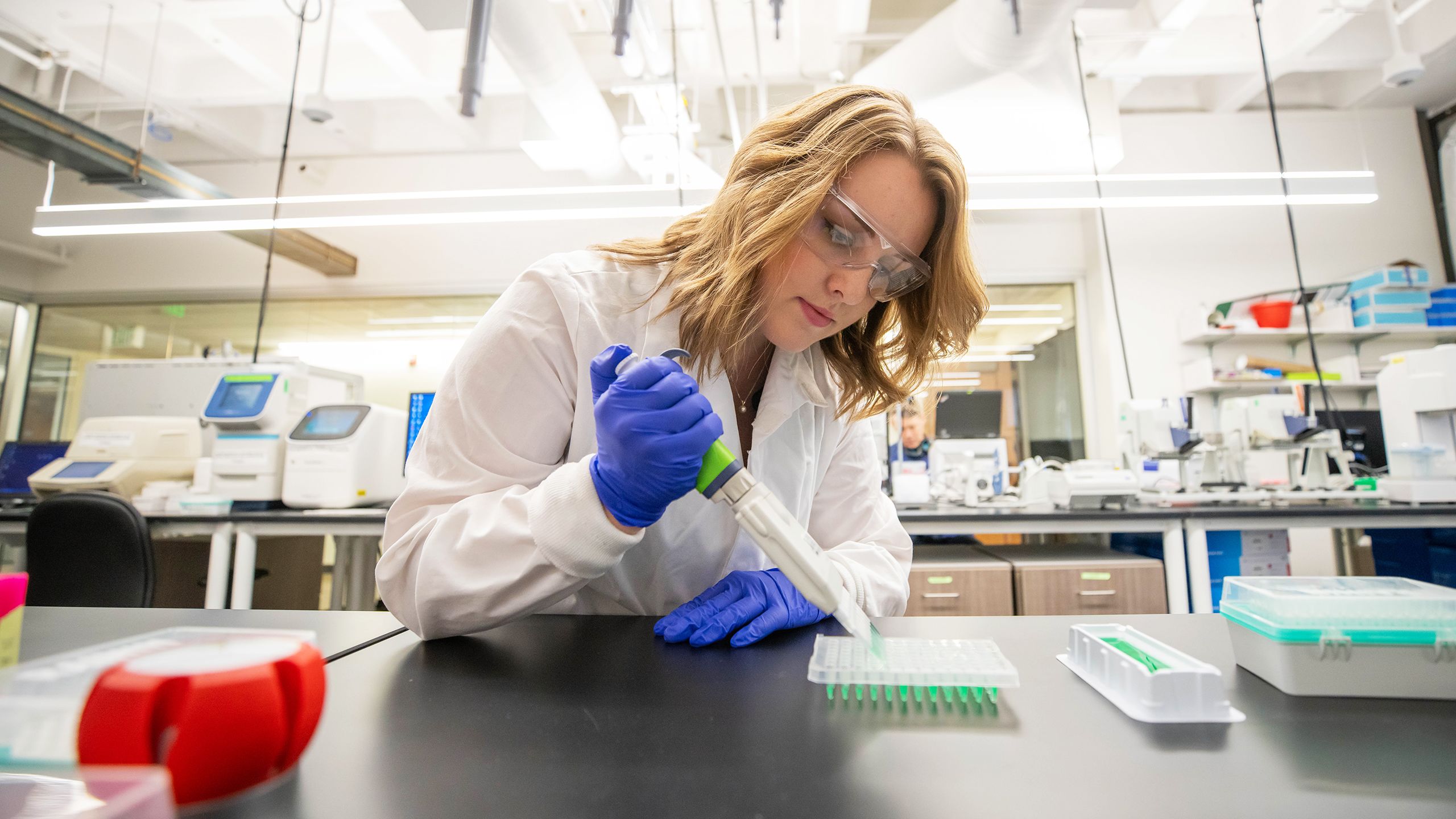 A student performing lab work in the Knight Campus science lab.